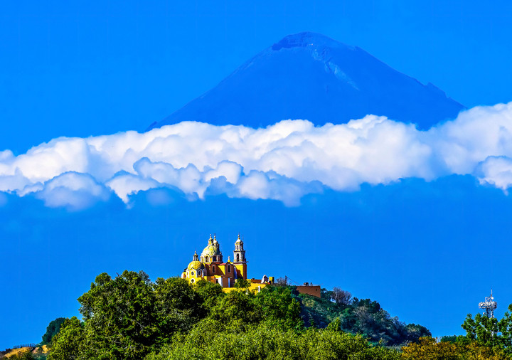 View on the Nuestra Señora de los Remedios church with the still active Popocatepetl volcano in background